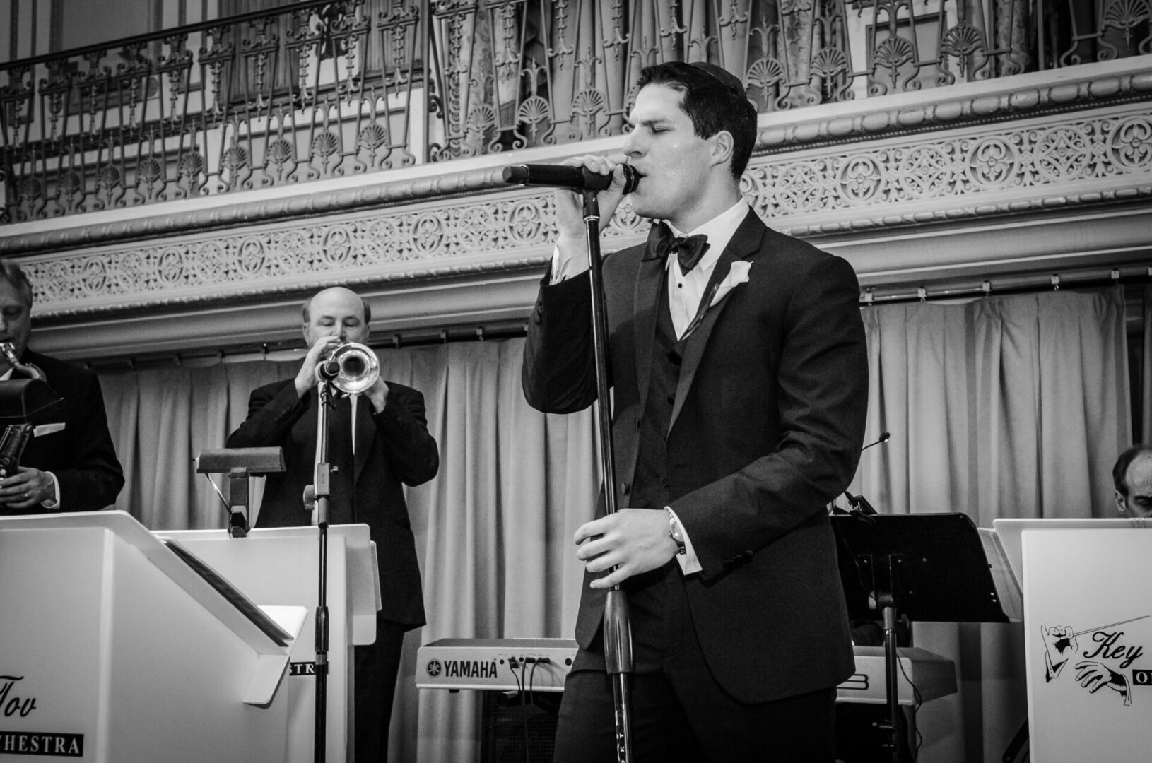 black and white picture of a man singing with eyes closes
